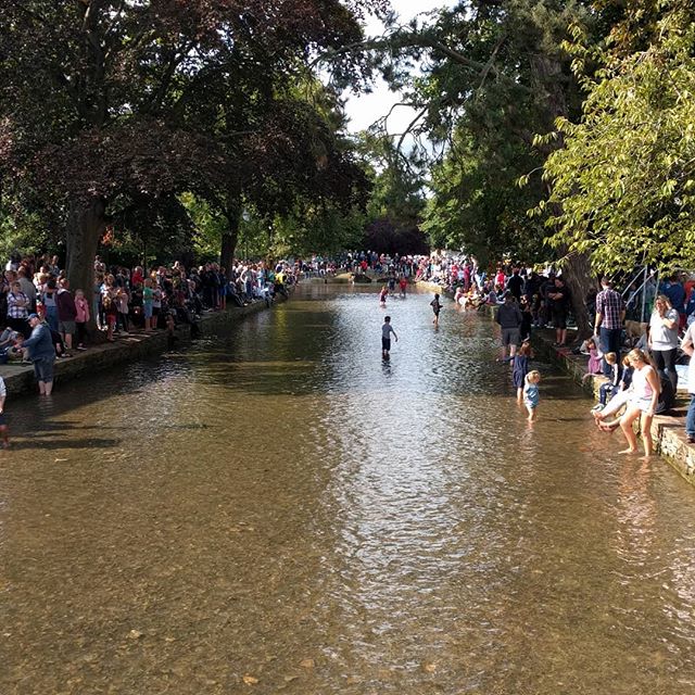A packed Bourton on the Water for the world renowned Football in the River!